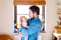 Young father holding his newborn baby son in his arm Royalty Free Stock Photo