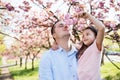 Young father holding small daughter outside in spring nature. Royalty Free Stock Photo