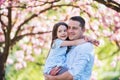 Young father holding small daughter outside in spring nature. Royalty Free Stock Photo