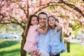 Young father holding small daughters outside in spring nature. Royalty Free Stock Photo