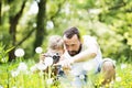 Young father with little boy with camera in summer park. Royalty Free Stock Photo