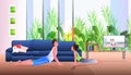 young father with little daughter doing stretching exercises while watching online video training program fatherhood Royalty Free Stock Photo