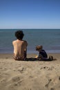 Young father and little daughter sitting on the beach and playing with sand Royalty Free Stock Photo