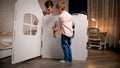 Young father with little son assembling toy cardboard house in children bedroom. Family having good time together. Kids Royalty Free Stock Photo