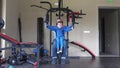 Young father and little son exercises on farce device at gym, healthy sport