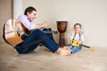 Young father and little son playing guitar Royalty Free Stock Photo