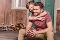 Young father with little son sitting on porch at backyard Royalty Free Stock Photo
