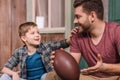 Young father with little son sitting on porch at backyard Royalty Free Stock Photo