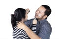 Young father painting a face of his daughter