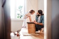 Young father painting small daugter`s nails in a bathroom at home.