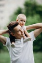 Young father piggyback adorable little daughter. Daddy and child