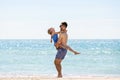 Young father play with daughter at sea beach Royalty Free Stock Photo