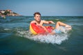 Young father playing with a child in the sea and makes mistake