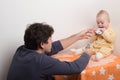 Father is playing with his baby. Young dad with a baby plays cards Royalty Free Stock Photo