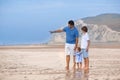 Young father playing with his son and baby daughter on beach Royalty Free Stock Photo