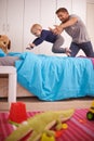 Playtime with dad. A young father playing with his young son at home. Royalty Free Stock Photo