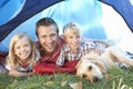 Young father poses with children in tent