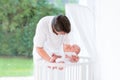 Young father putting his newborn baby into crib Royalty Free Stock Photo