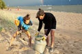 Young father with son on beach digging pit under the rainbow, playing, looking for treasure, lifestyle happy family on