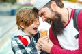 Young father and son enjoying icecream and having fun together. Happy emotional family outdoors. Vacation, summer time, walking at Royalty Free Stock Photo