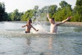 Young father and son swimming in river