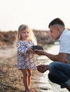Young father spends his time with his little daughter