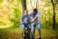 Young father teaching his smiling son how to ride a bike