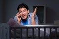 The young father under stress due to baby crying at night Royalty Free Stock Photo