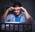 Young father under stress due to baby crying at night