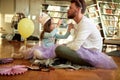 A young father waiting for his daughter to put a lipstick on his lips while they preparing for a ballet training at home. Family,