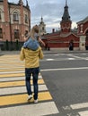 A young father walks with his daughter around the city. A man holds a child by the hand. Royalty Free Stock Photo