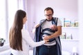 Young father wrapping his newborn baby son into sling Royalty Free Stock Photo