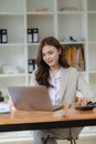 Young female accountant, company worker working with laptop and accounting documents Royalty Free Stock Photo