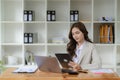 Young female accountant, company worker working with laptop and accounting documents Royalty Free Stock Photo