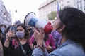 Young female activist using a megaphone to speak about the climate emergency