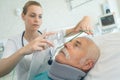 Young female anesthetist putting oxygen mask on senior patient Royalty Free Stock Photo