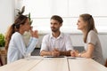 Young female applicant talking to diverse hr managers at office