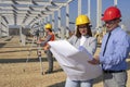 Young Female Architect and Construction Engineer Checking the Blueprint on Construction Site Royalty Free Stock Photo