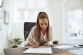 Young female architect drafting up a design in an office