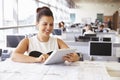 Young female architect using tablet computer at her desk Royalty Free Stock Photo