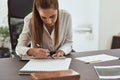 Young female architect working on designs at her office desk Royalty Free Stock Photo