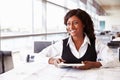 Young female architect working at her desk, looking away Royalty Free Stock Photo