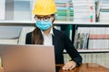 The young female architect works on the laptop in the office