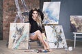 Young female artist painting abstract picture in studio, beautiful woman portrait Royalty Free Stock Photo