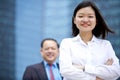 Young female Asian executive and senior Asian businessman smiling portrait Royalty Free Stock Photo