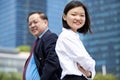 Young female Asian executive and senior Asian businessman smiling portrait Royalty Free Stock Photo