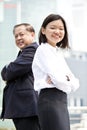 Young female Asian executive and senior Asian businessman smiling portrait Royalty Free Stock Photo