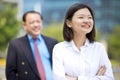 Young female Asian executive and senior Asian businessman smiling portrait Royalty Free Stock Photo