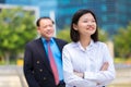 Young female Asian executive and senior Asian businessman smiling portrait Royalty Free Stock Photo