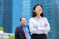 Young female Asian executive and senior Asian businessman smiling portrait Royalty Free Stock Photo